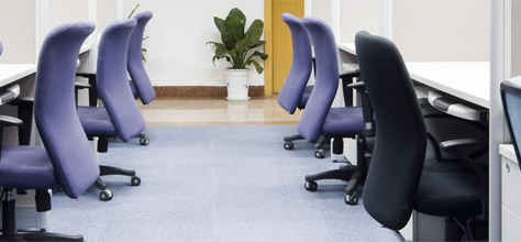 An Office Hallway with Desks and Chairs 